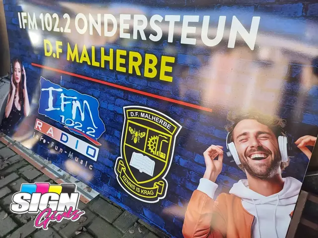 Promotional signboard for IFM 102.2 and D.F. Malherbe